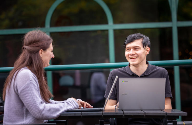 Students Smiling With Laptops