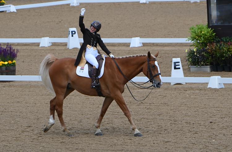 Rider From Iraq Punches The Air In Celebration