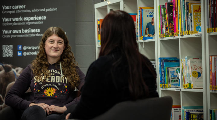 Student Support staff member sat opposite a student